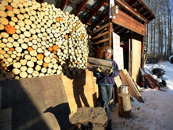 &lt;p&gt;Owner of the North Fork Hostel Oliver Meister gathers wood from his supply on Monday, January 21, in Polebridge. (Brenda Ahearn/Daily Inter Lake)&lt;/p&gt;