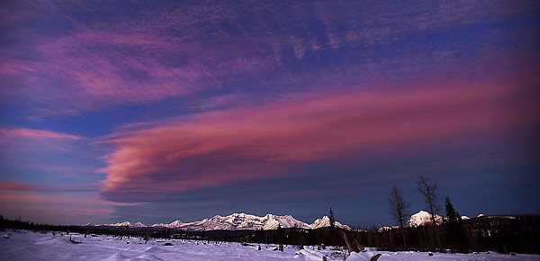 &lt;p&gt;The setting sun turns clouds pink over the mountain peaks of Glacier National Park north of Polebridge.&lt;/p&gt;