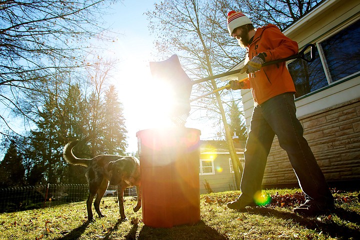 &lt;p&gt;JEROME A. POLLOS/Press Lars Johansson dumps leaves into a garbage can Monday as he rakes his front yard on Government Way in Coeur d'Alene with his dog. The sunny weather and lack of snow motivated people to get outdoors despite the subfreezing temperatures.&lt;/p&gt;