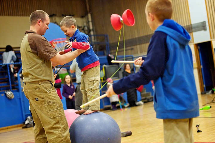 &lt;p&gt;JEROME A. POLLOS/Press Scott DuCoeur helps his son Joe, 6, work on his balance ball skills during an after-school parent and child workshop Wednesday at Sorensen Magnet School. The week-long workshop culminates with a performance tonight at North Idaho College's Schuler Performing Arts Center where the students will showcase the skills they learned from performers Matt Baker and Aaron Gregg.&lt;/p&gt;