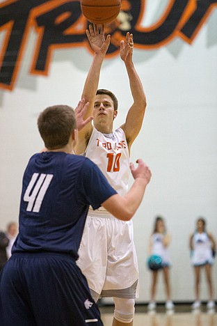 <p>Matt Hillman of Post Falls shoots and scores a three-point shot during Tuesdays game.</p>