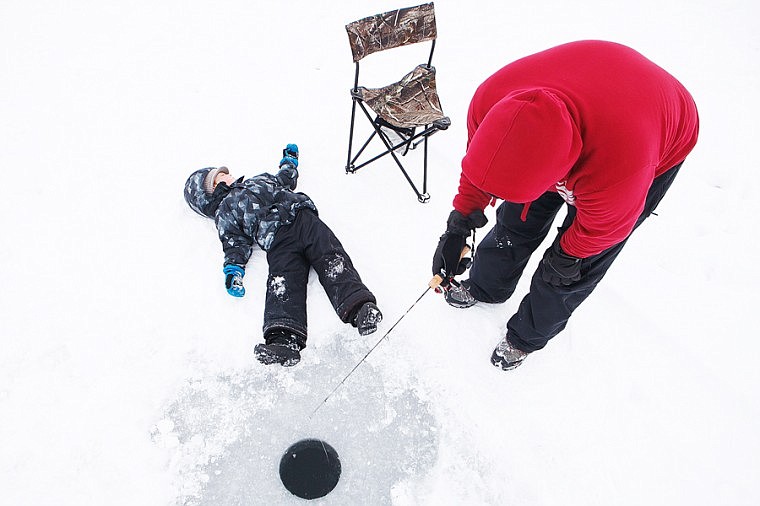 &lt;p&gt;Patrick Cote/Daily Inter Lake Dane Reynolds, 5, lays on the ice while his dad Tony fishes for pike Saturday morning during the 42nd annual Sunriser Lions Smith Lake Fish Derby. Saturday, Dec. 29, 2012 in Kila, Montana.&lt;/p&gt;