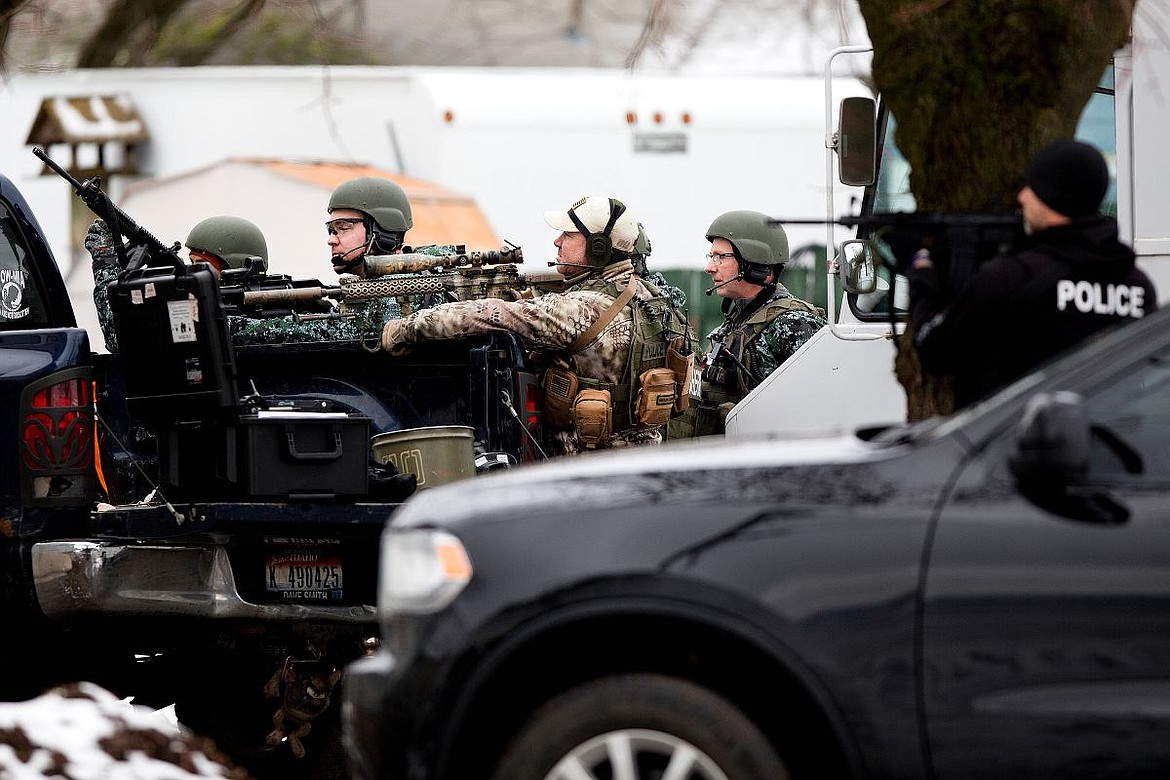 &lt;p&gt;Members of the Kootenai County Sheriff and Coeur d'Alene Police SWAT teams closely watch a residence on Best Avenue occupied by 22-year-old Brandon Kremer of Post Falls on Thursday in Coeur d'Alene. Kremer, who has multiple felony warrants, was arrested after a standoff with law enforcement.&lt;/p&gt;