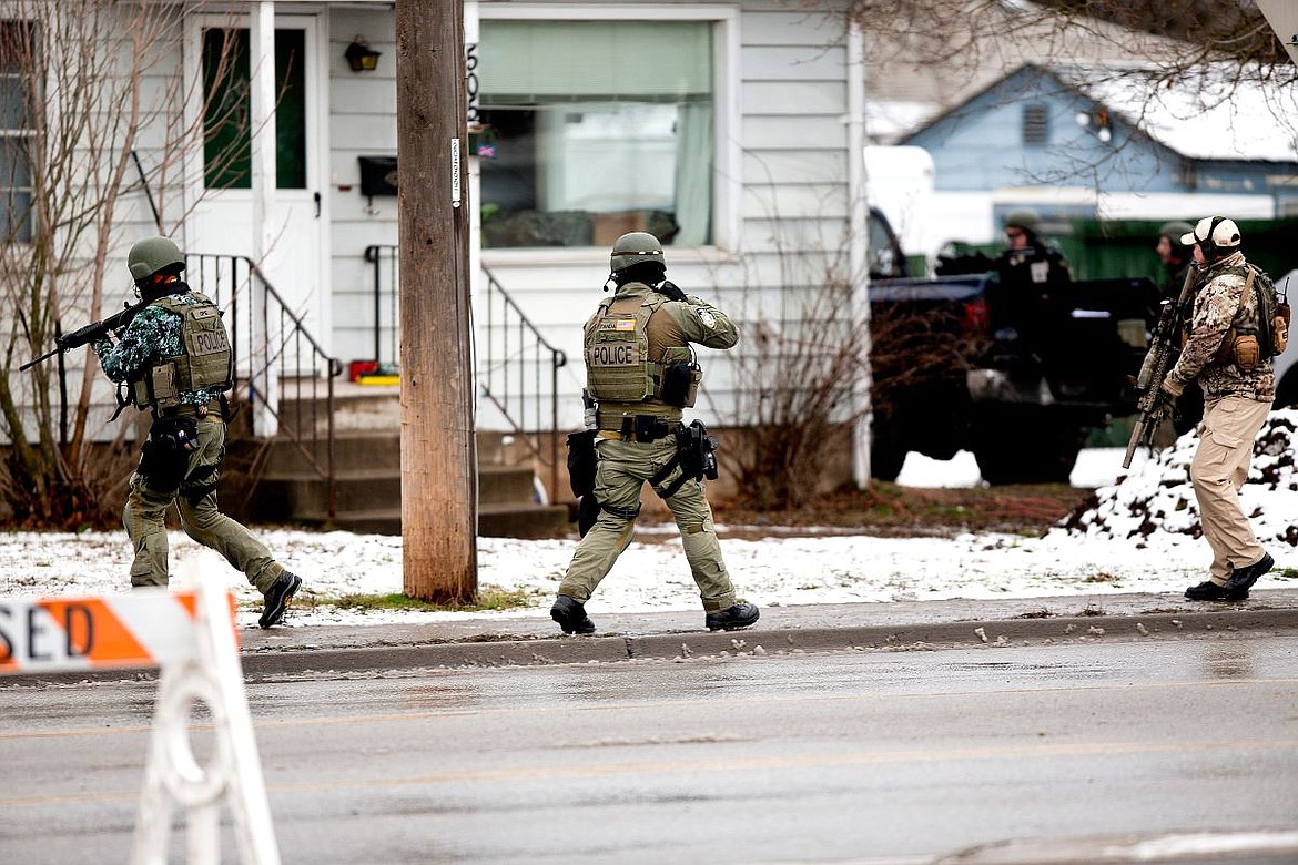 &lt;p&gt;Members of the Kootenai County Sheriff and Coeur d'Alene Police SWAT teams closely watch a residence on Best Avenue occupied by 22-year-old Brandon Kremer of Post Falls on Thursday in Coeur d'Alene. Kremer, who has multiple felony warrants, was arrested after a standoff with law enforcement.&lt;/p&gt;