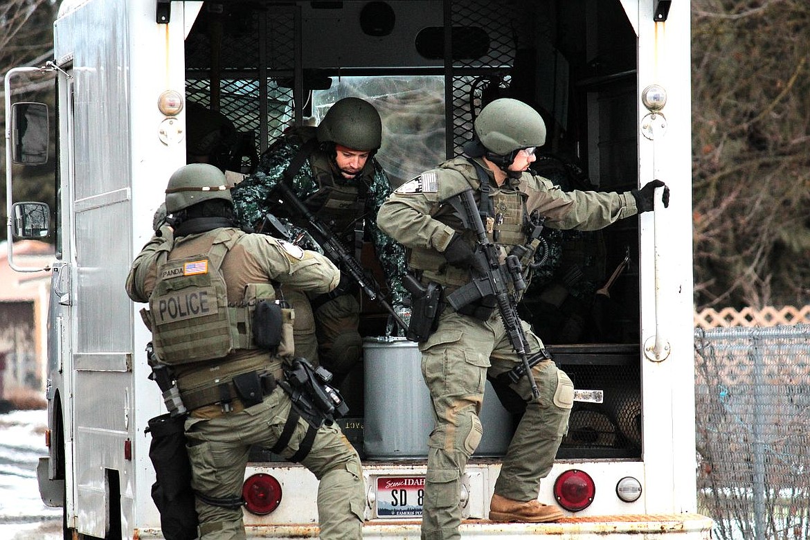 &lt;p&gt;Kootenai County Sheriff and Coeur d'Alene Police SWAT team members jump out of a van during a standoff between law enforcement and 22-year-old Brandon Kremer on Thursday on Best Avenue in Coeur d'Alene. Kremer, of Post Falls, had multiple felony warrants prior to the hour-long standoff, which ended with Kremer's arrest.&lt;/p&gt;