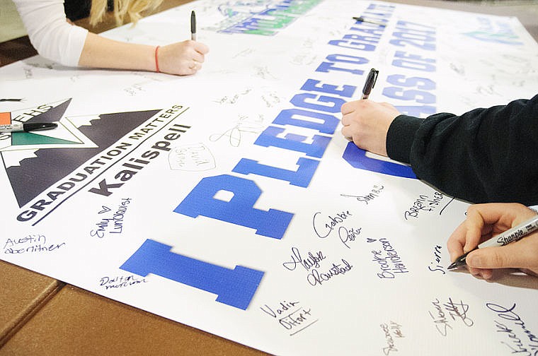 &lt;p&gt;Students sign a banner Friday afternoon during the Graduation Matters Kalispell event.&lt;/p&gt;