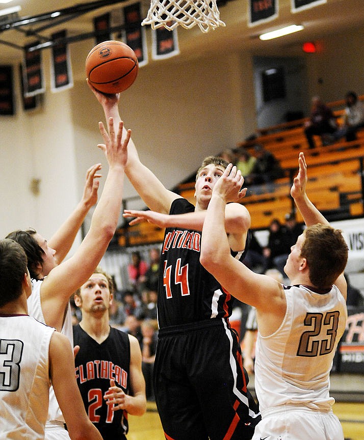 &lt;p&gt;Flathead&#146;s Trae Habel lofts a shot over a trio of Helena High defenders for a basket during Friday&#146;s Western AA boys basketball game at Flathead High School. (Aaric Bryan/Daily Inter Lake)&lt;/p&gt;