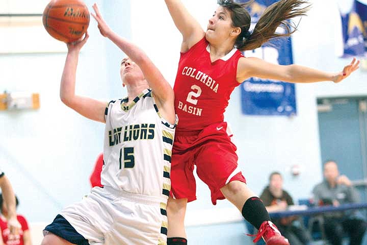 Mikaela Loudon (15) is fouled by Brianne Green (2) during Tuesday's game between MLCA and CBSS. Loudon scored 11 points for the Lions.