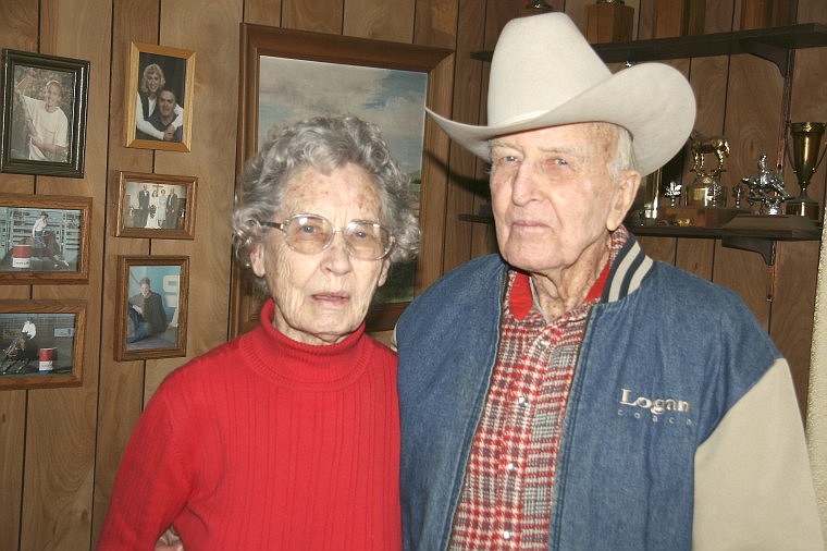&lt;p&gt;George and Alberta Richmond pose by family photos and some of his trophies at their home in Hayden on Saturday.&lt;/p&gt;