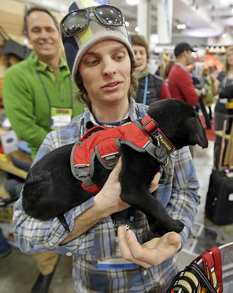 &lt;p&gt;James Gould holds a puppy wearing the Web Master Harness in the Ruffwear booth at the Outdoor Retailer Winter Market show Wednesday, Jan. 22 in Salt Lake City. Ruffwear, is a maker of performance dog gear in Bend, Ore.&lt;/p&gt;