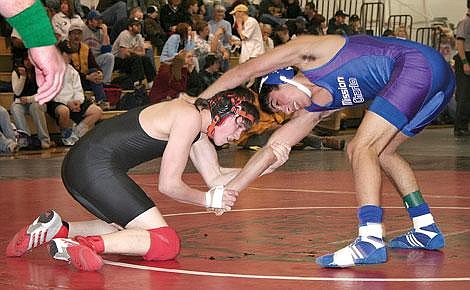 Photo by Ryan Brubaker&lt;br&gt;Wrestling in the 145-pound class, Kyle Steinebach of the Plains-Hot Springs Savage Horsemen tries to take down Vugar Garayev of Mission/Charlo during the Western B/C Divisional Wrestling Tournament at Darby. Steinebach pinned him in 4:20 and eventually took first place.