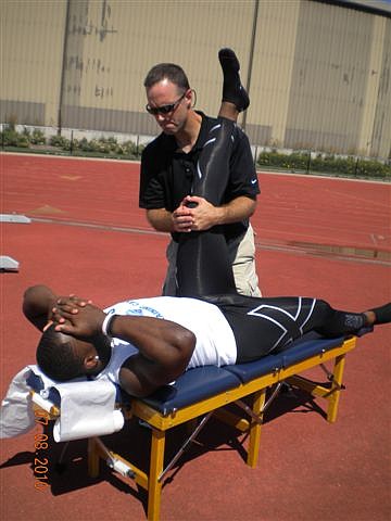 Local chiropractor Tye Leduc stretches Philadelphia Eagles' linebacker Simoni Lawrence during last summer's training camp in Minneapolis, Minn.