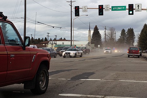 &lt;p&gt;Several police units follow as a Kootenai County Sheriff's Department vehicle crosses Appleway Avenue at the Fourth Street intersection.&lt;/p&gt;