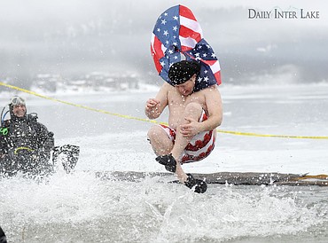 <p>Kyler Morrison of Whitefish jumps into Whitefish Lake during the Penguin Plunge on Saturday. The event for the Whitefish Carnival raised nearly $25,000 for the Special Olympics. (Aaric Bryan/Daily Inter Lake)</p>