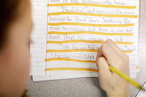 &lt;p&gt;Shenoa Gosney, 9, prepares a draft of her story assignment on a sheet of paper marked with a highlighter to remind her to double space her lines.&lt;/p&gt;