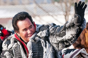 <p>Grand marshall and noted Las Vegas entertainer Wayne Newton waves to the crowd Saturday afternoon during the Whitefish Winter Carnival Parade.</p>