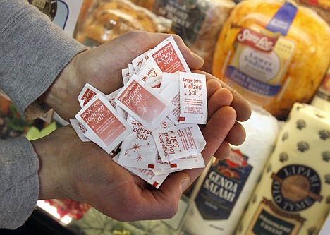 &lt;p&gt;Employee Jake Hegedus holds packets of salt at a market in Cleveland on Tuesday, Feb. 7, 2012. Nearly all Americans consume much more sodium than they should, according to a report from the Centers for Disease Control and Prevention. Most of the sodium comes from common restaurant or grocery store items. (AP Photo/Amy Sancetta)&lt;/p&gt;