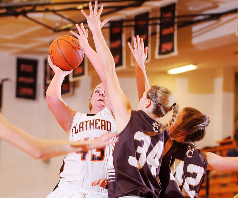 &lt;p&gt;Flathead senior post Jenessa Heine (43) shoots over Helena Capital defenders Tjaden Pallister (34) and Kyra Dawes (42) Friday night at Flathead High School.&lt;/p&gt;