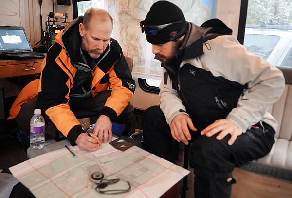 &lt;p&gt;Gary Presson, left, and Rob Brenneke of the Flathead County
Mountain Rescue team &#160;talk about map and compass readings Thursday
morning during the search a missing skier in Jewel Basin. The
skier's body later was found buried by an avalanche.&lt;/p&gt;