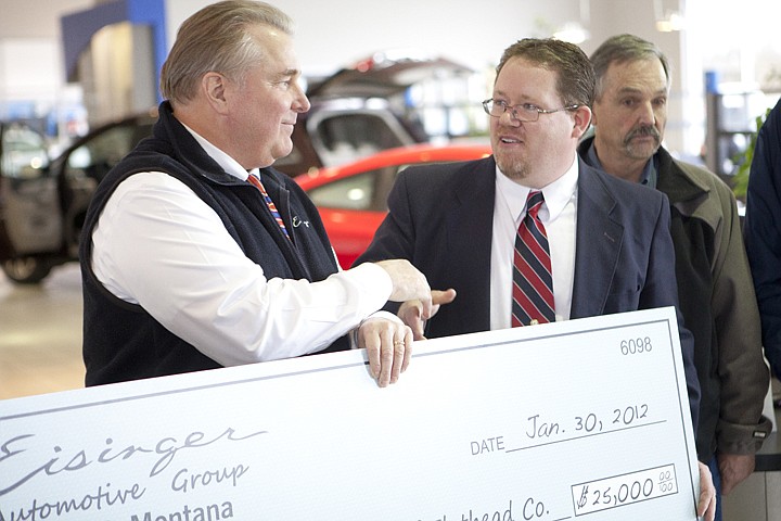 &lt;p&gt;Executive director of Big Brothers Big Sisters of Flathead
County Tim Sievers, right, accepts a donation check from Greg
Eisinger at Eisinger Honda Monday morning. The Eisigner Automotive
group donated $25,000 to the nonprofit program. &quot;This is a game
changing donation for our organization,&quot; Sievers said.&lt;/p&gt;