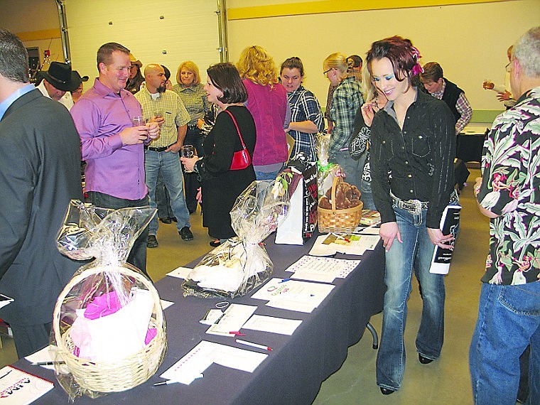 People look at silent auction items during the silent auction at the Columbia Basin Cancer Foundation's auction and dinner.