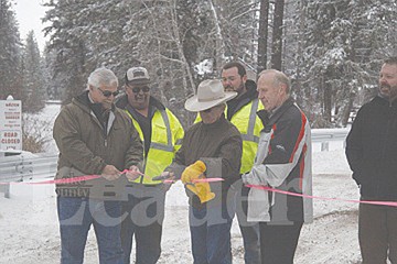 &lt;p&gt;CSKT council member Leonard Gray cuts the ribbon on a new, concrete tri-beam bridge that has replaced an old log and plank structure on Michel Road, about three miles east of Ronan.&lt;/p&gt;