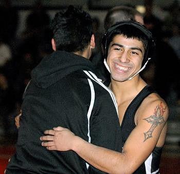 Alejandro gets a hug from Joaquin after Alejandro won his match against a Big Sky opponent on Jan. 20, pinning his opponent in 27 seconds in the Flathead gym. Karen Nichols/Daily Inter Lake