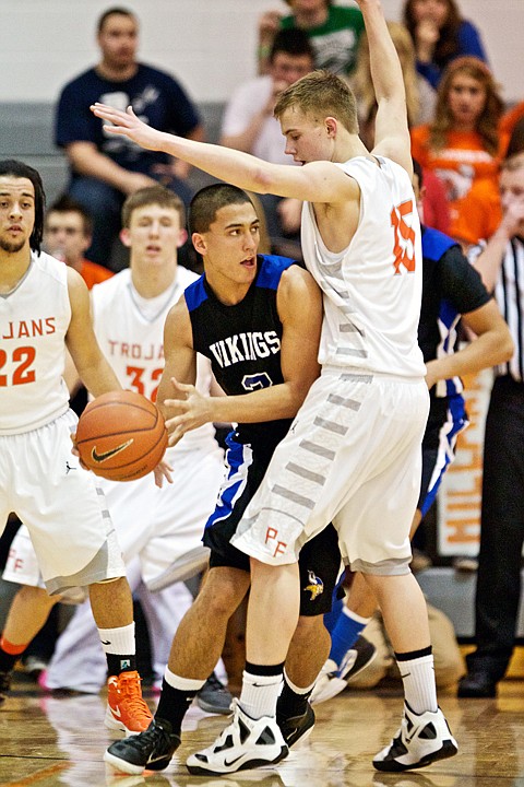 <p>JEROME A. POLLOS/Press Coeur d'Alene High's Travis Tackett looks for a teammate to pass the ball to as Luke Thoreson from Post Falls High applies the defensive pressure.</p>