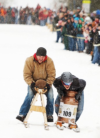 <p>Brandon Kelman, left, barely edges out Nic Lee during their race Saturday afternoon in the World Championship Barstool Races at the 35th Annual Cabin Fever Days in Martin City. Saturday, Feb. 9, 2013 in Martin City, Montana. (Patrick Cote/Daily Inter Lake)</p>
