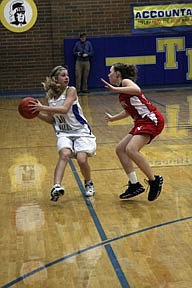 Lady Hawks freshman Erica Sorlie handles the ball for Thompson Falls.