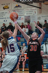 Plains junior Kayla Revier extends for a rebound during a 27-54 loss Trotter loss at Bigfork on Friday.