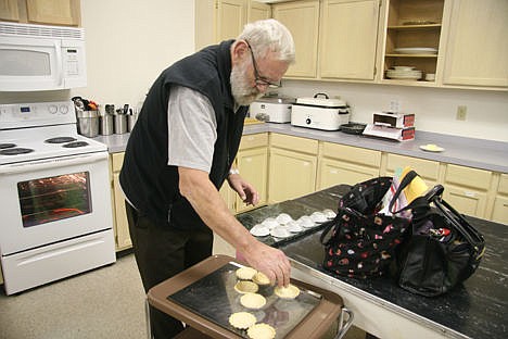 &lt;p&gt;Ron Hansen of Post Falls flips sandbakkels upside down to remove them from their tins during a cookie baking session Sunday.&lt;/p&gt;