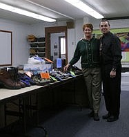 Jan Parmalee, of Sanders County Public Health, and Jerry Pauli, Thompson Falls superintendent, stand with the 55 pairs of used shoes raised in Sanders County to raise awareness of the danger of tobacco use.