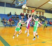 Cary Chamberlain makes a layup despite the presence of two Valley Christian defenders in a game last week.