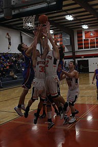 Taylor Firestone and Tanner Ostrum battle a pair of Vikings for a rebound during Saturday's loss to Bigfork.