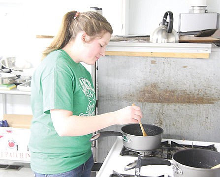 &lt;p&gt;4-H member Natalee Wheeler of Lake Mary Ronan lends a hand in the kitchen on Saturday.&lt;/p&gt;