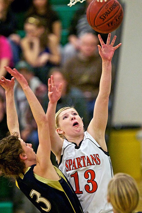 <p>Priest River's Steffie Pavey elevates for a layup against Ashly George from Timberlake High during the 3A District championship game Thursday at Lakeland High.</p>