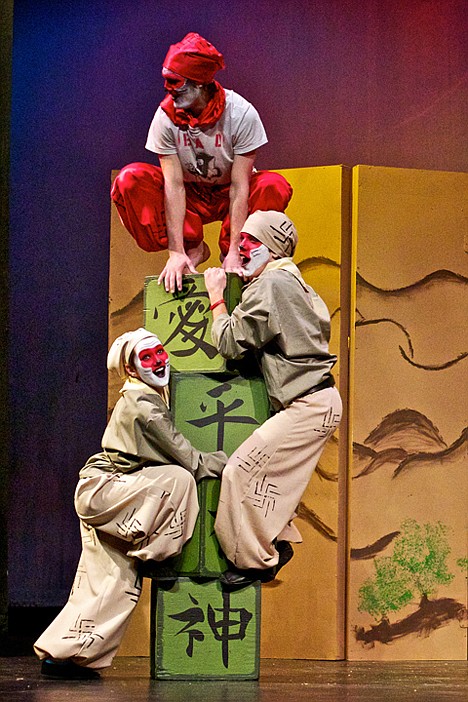 <p>Eston Townsend, who plays the Monkey King, climbs on top of a tower of blocks while Meghan Tiffany, left, and Kole Smith take part in the activity.</p>
