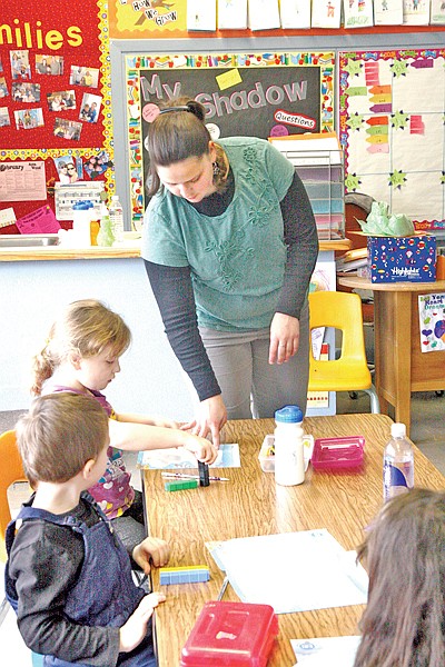 Kindergarten teacher Erin Bothman instructs Melanie Peek and Kyle Svendsbye on Wednesday during a math activity at Asa Wood Elementary School. The Libby School District now needs to decide what to do in the future – with or without bond funding.