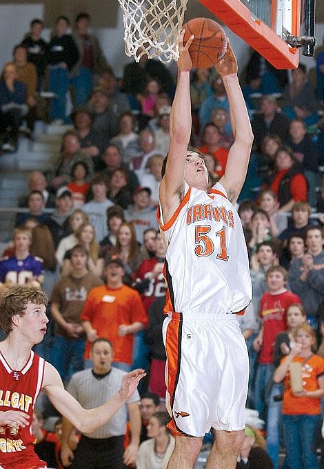 Flathead's Brock Osweiler hits a layup during second half action Thursday while Hellgate's Nathan Klette watches. Osweiler contributed a game-high 23 points to Flathead's 70-48 win. Karen Nichols/Daily Inter Lake