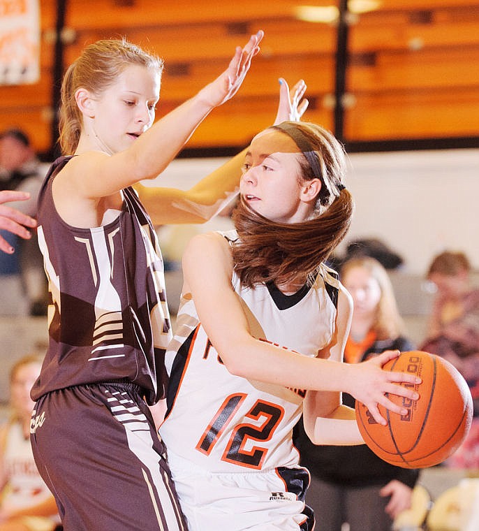 &lt;p&gt;Flathead sophomore guard Stephanie Wilson (12) looks to pass while being guarded by Helena Capital junior Rayna Pilgeram (24) Friday night during Western AA play at Flathead High School.&lt;/p&gt;