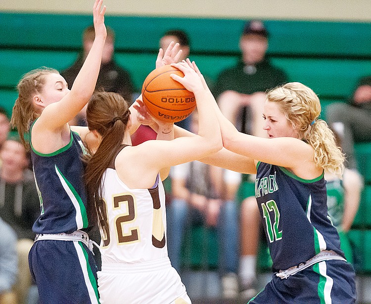 &lt;p&gt;Glacier sophomore guard Hailee Bennett (left) and Glacier senior forward Hannah Atlee (12) pressure Helena Capital junior McKenzie Johnston (32) Saturday afternoon during Western AA girls basketball play at Glacier High School. (Patrick Cote/Daily Inter Lake)&lt;/p&gt;