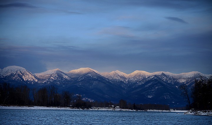 &lt;p&gt;The Swan Mountains are edged by light at sunset in this view over the Flathead River from Lower Valley Road on Monday.&lt;/p&gt;