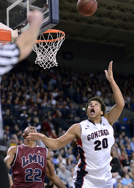 &lt;p&gt;Loyola Marymount's Godwin Okonji fouls Gonzaga's Elias Harris (20) during the second half Saturday night at Spokane. No. 6 Gonzaga defeated the Lions 74-55.&lt;/p&gt;