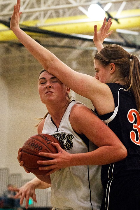 <p>Timberlake's Cassie Thompson is fouled by Liz Halcro, of Priest River, during the third quarter.</p>