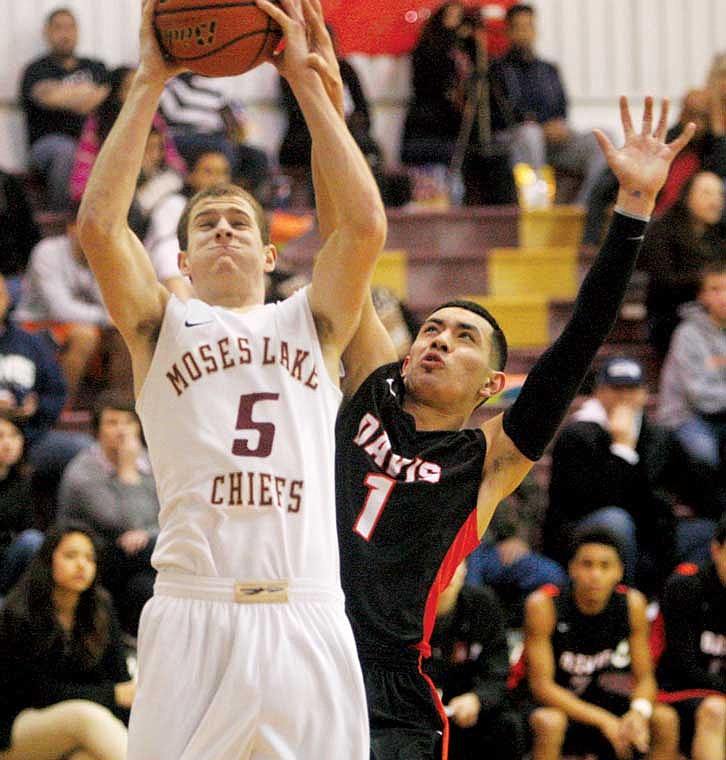 Moses Lake senior forward Nick Sutherland (5) is fouled by a Davis defender. The Chiefs lost, 60-64, and Sutherland scored eight points.