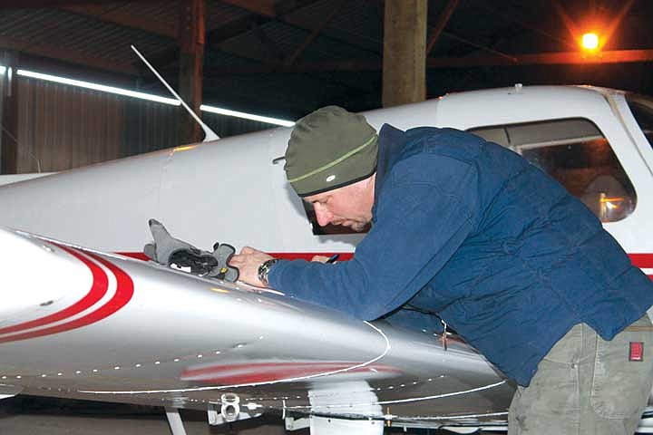 Amateur pilot Dave Watson, of Moses Lake, checks the map before every flight.