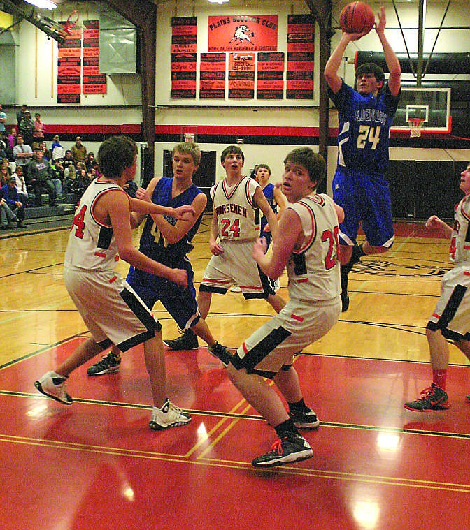 &lt;p&gt;Bluehawk Dalton Hooten shoots over Aaron Baker's head in the rival game on Thursday, Feb. 6.&#160;&lt;/p&gt;