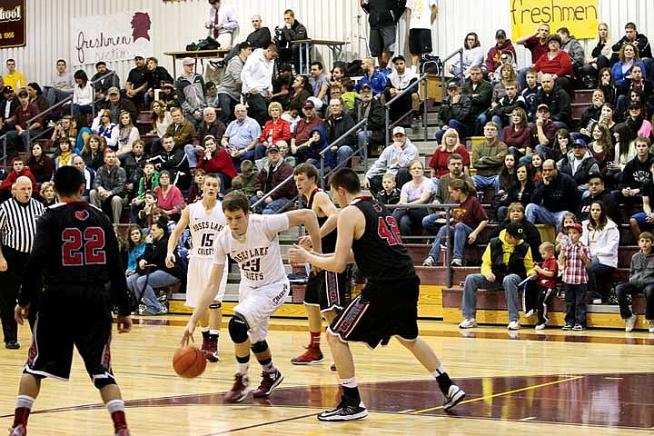 Easton Baker drives across the top of the key during the first quarter of the game against Sunnyside Friday, Feb. 8.