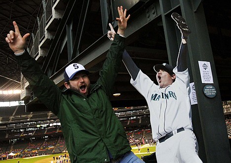 &lt;p&gt;Brandon Bogart, left, mimics Seattle Mariners baseball player Felix Hernandez's celebration in cutout form of his perfect game pitched last year at Safeco Field on Jan. 26 in Seattle.&lt;/p&gt;